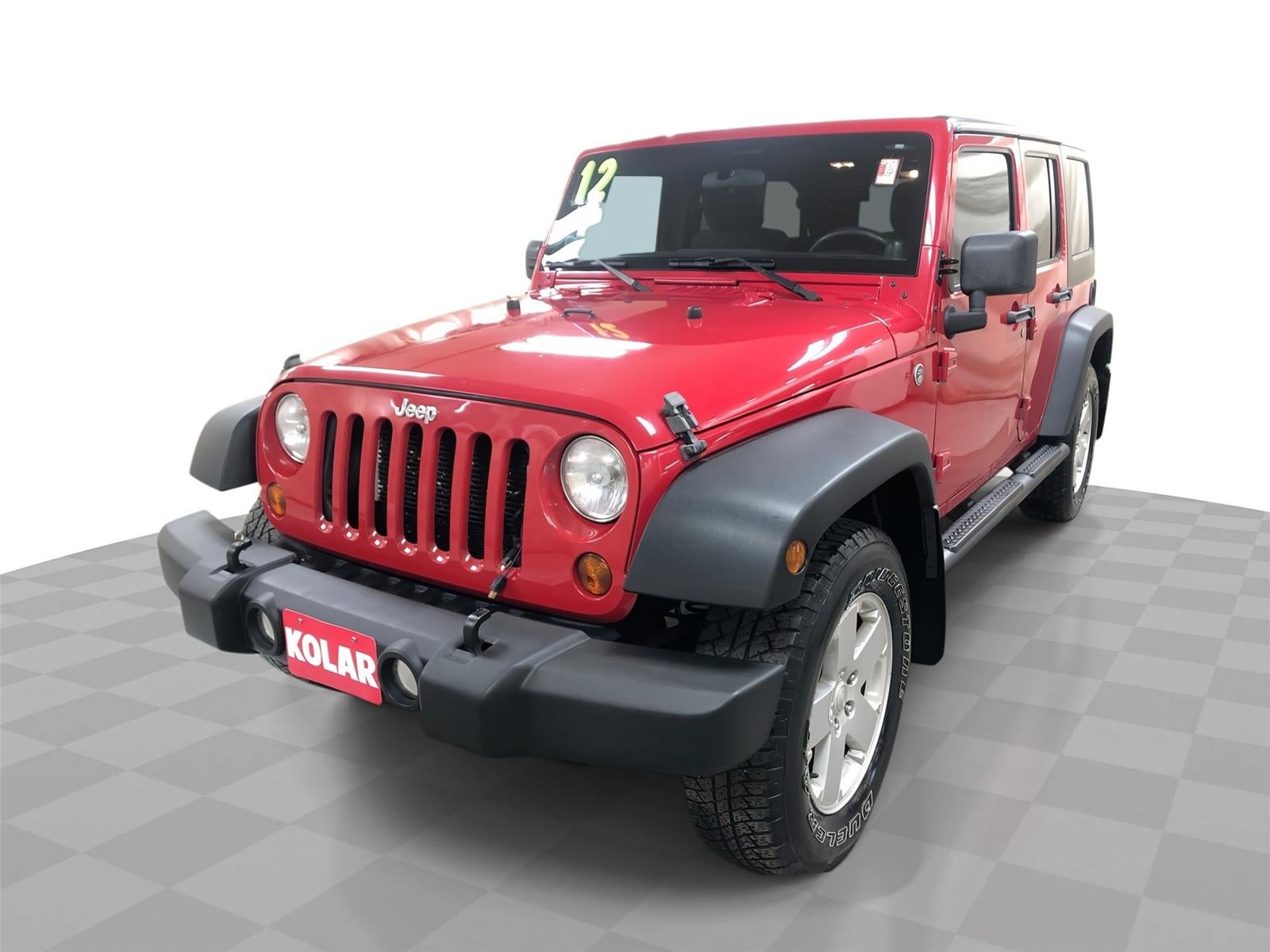 2012 Jeep Wrangler Unlimited Sport in Red — front three-quarter view